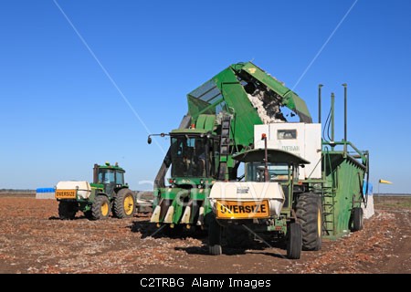a-john-deere-tractor-attached-to-a-cotton-module-builder-or-compacting-c2trbg.jpeg